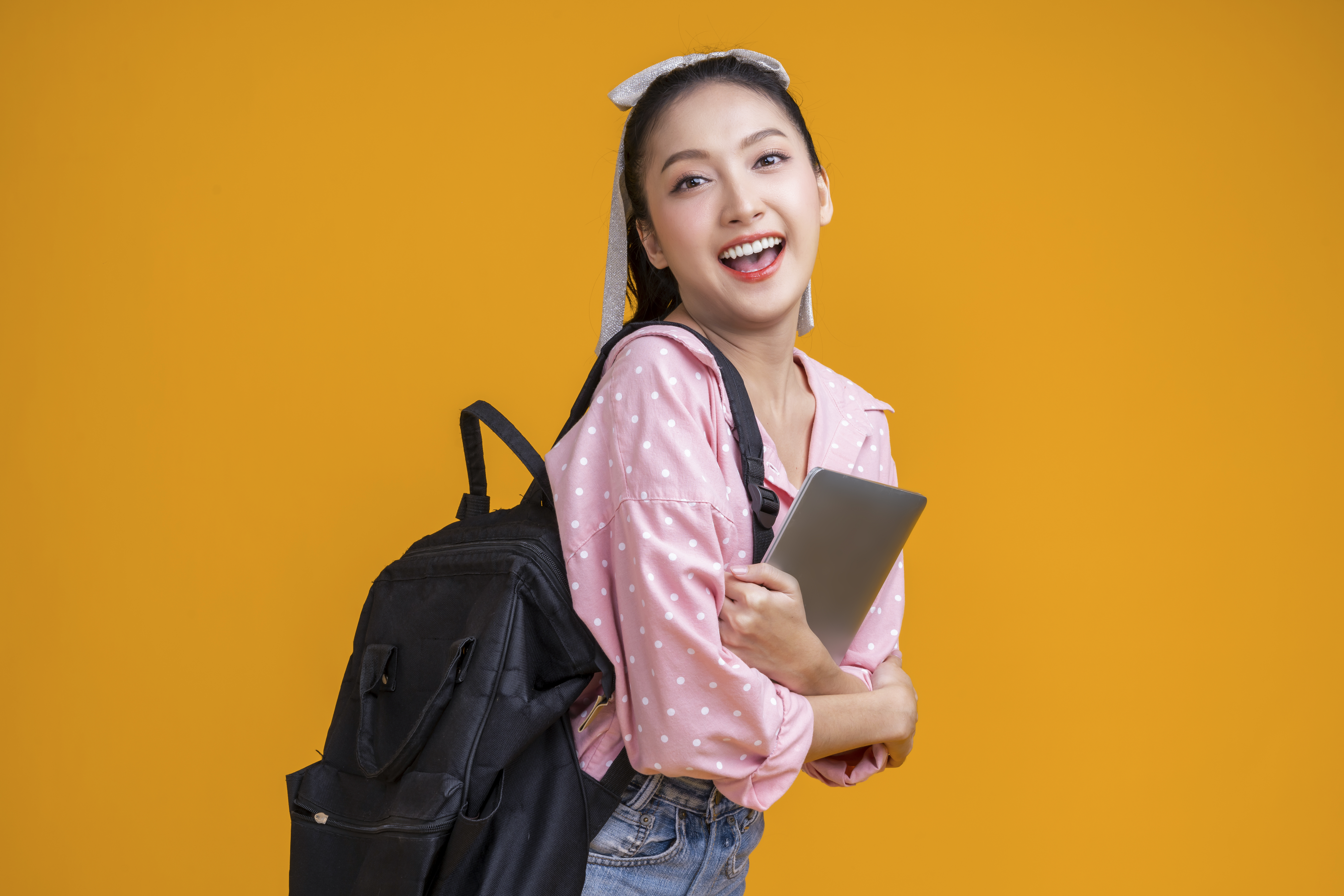 asian-collage-female-woman-smiling-cheerful-joy-face-expression-hand-hold-notebook-tablet-with-backpack-ready-schoolhappiness-positive-young-asia-woman-confident-smile-back-school-lifestyle