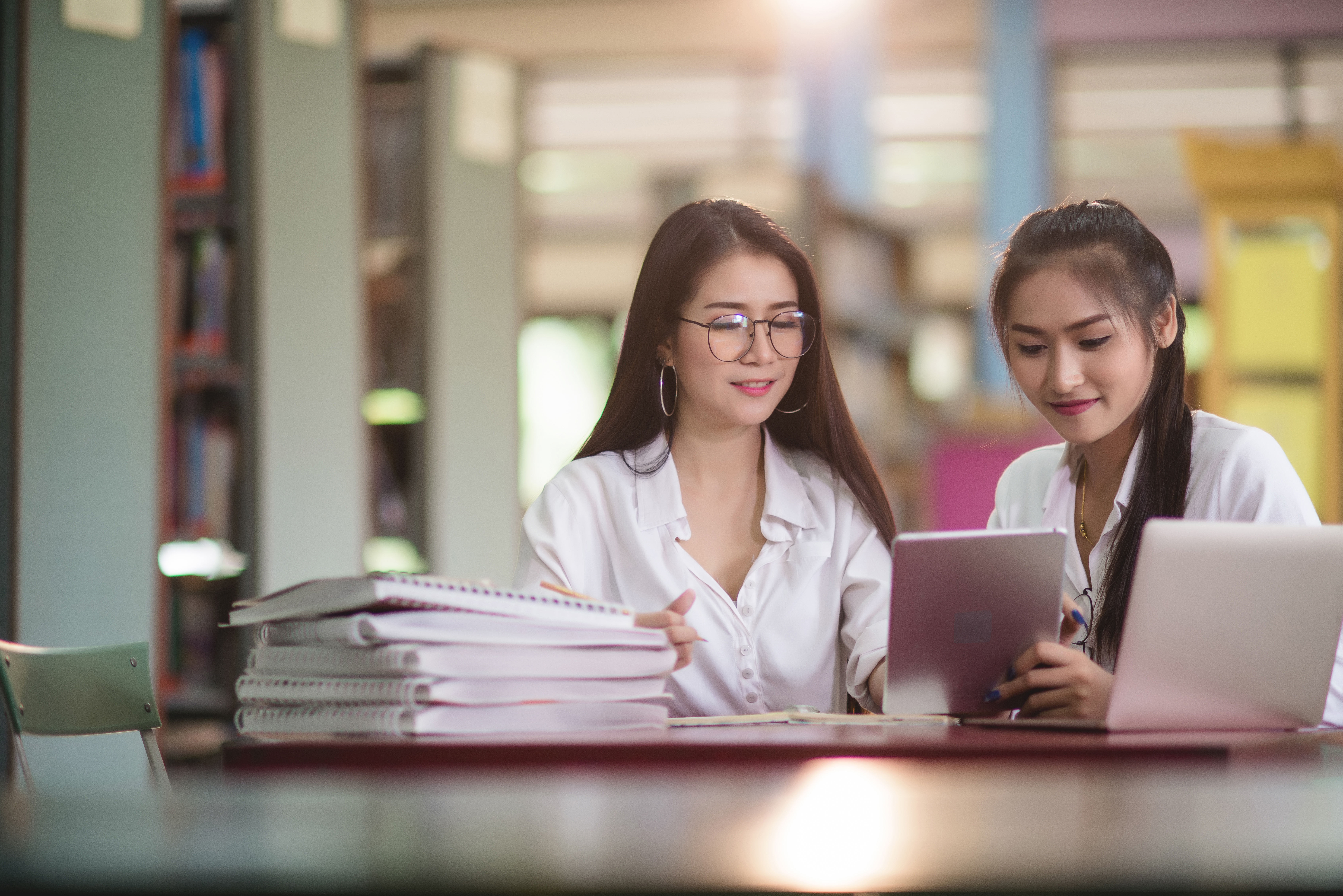 young-students-learning-library-bookshelves